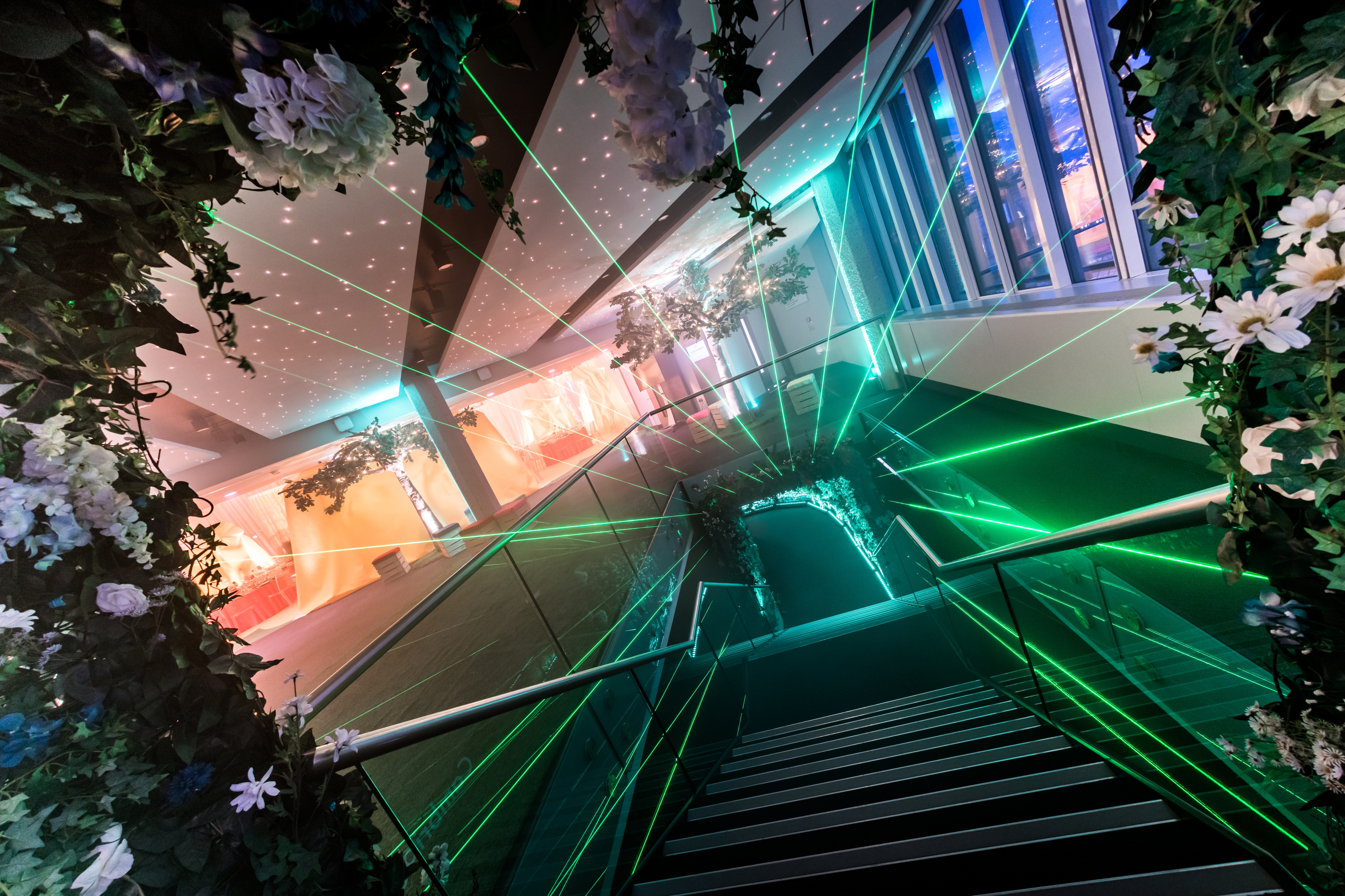 Mountbatten event space with floral stairway and vibrant lighting for corporate or celebratory events.