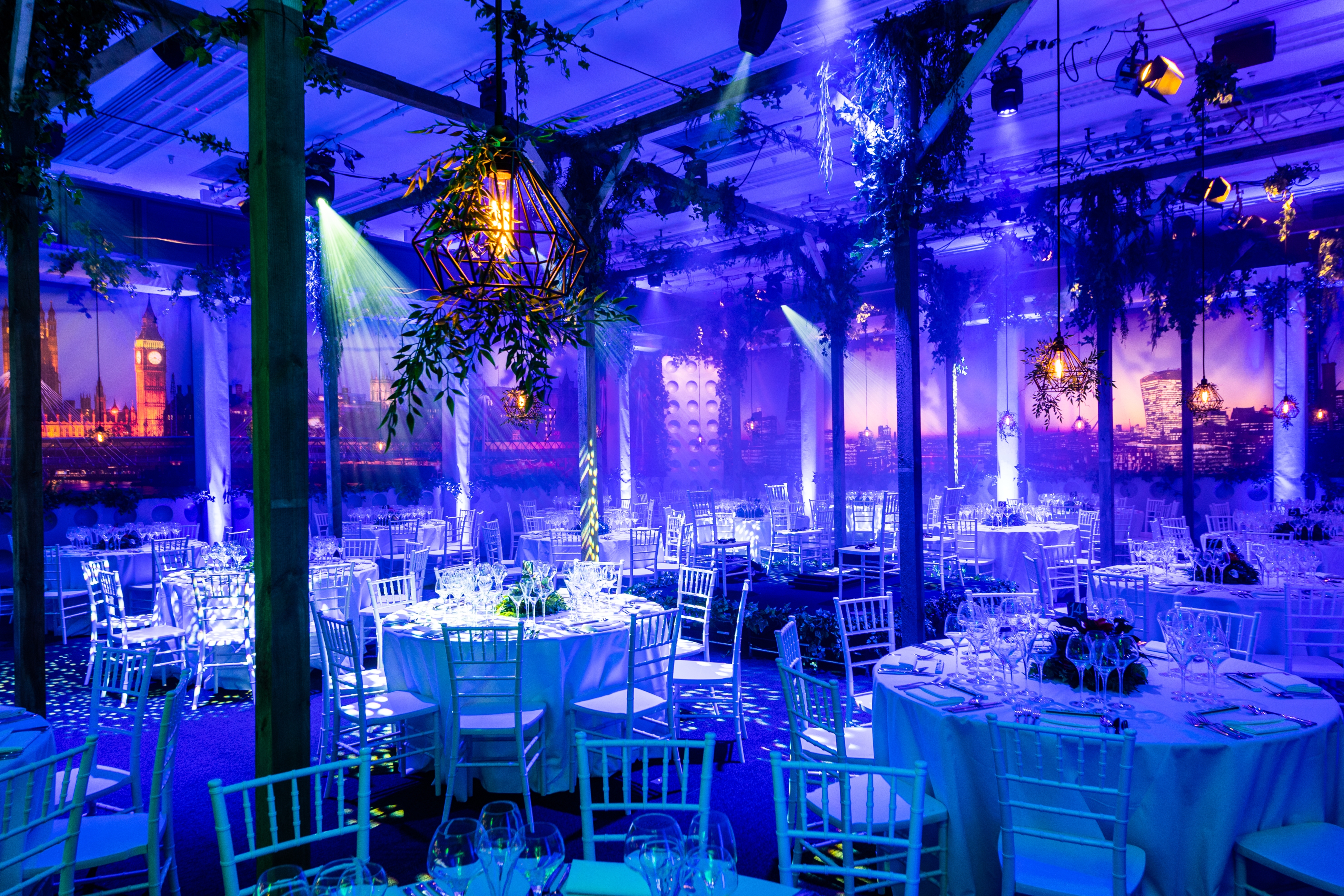 Elegant event space in QEII Centre, featuring soft blue lighting and city views.