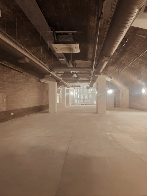 Spacious industrial venue with exposed brick for creative events at One America Square.