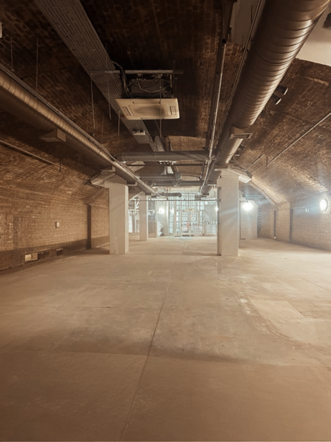 Spacious industrial venue with exposed brick for creative events at One America Square.