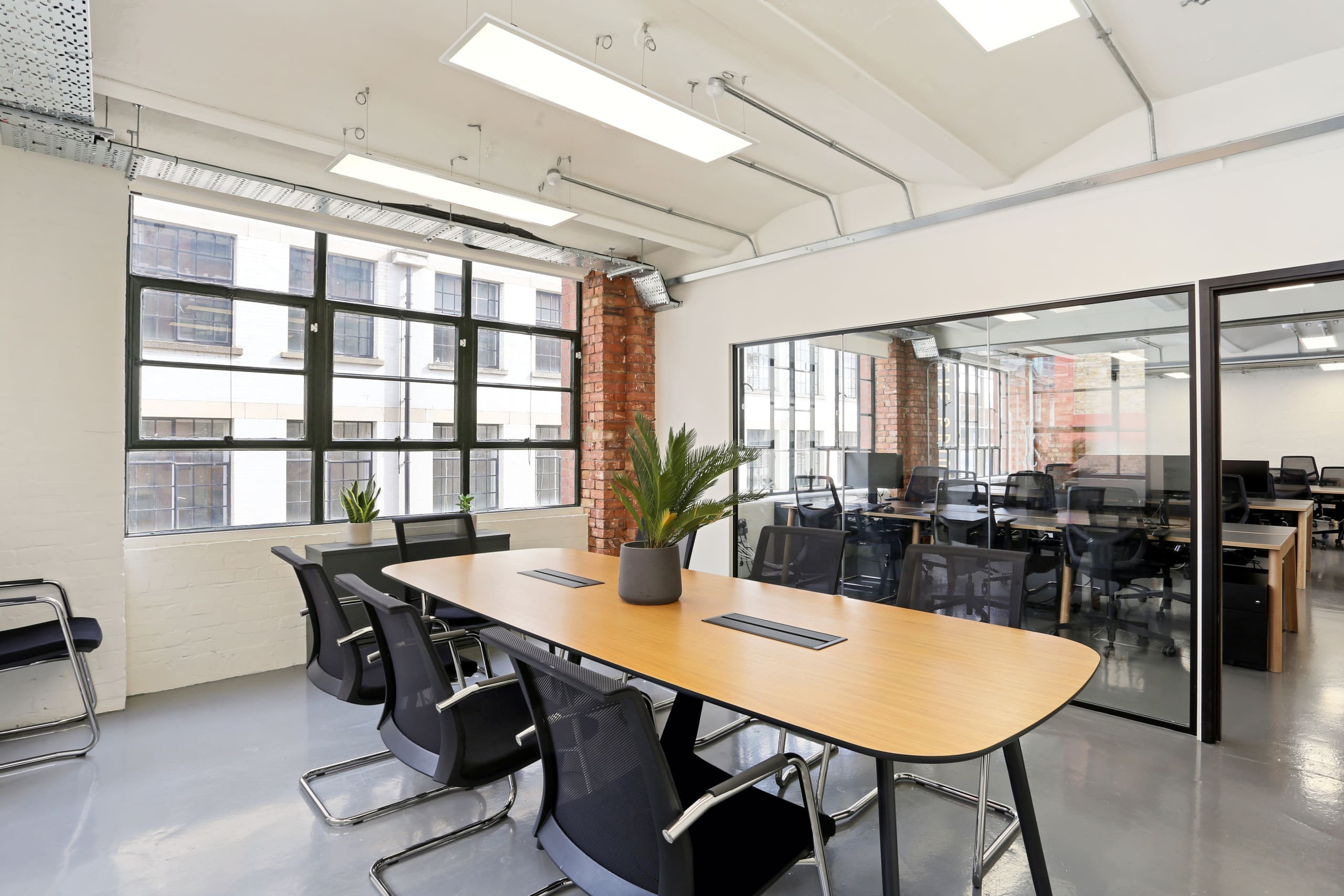 Modern meeting room in Phoenix House with large table, ideal for workshops and presentations.