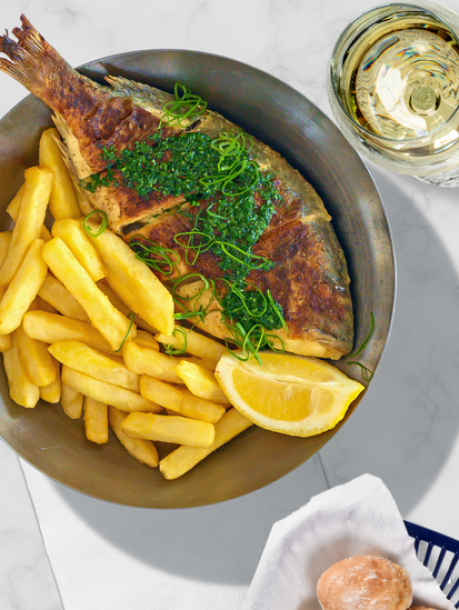 "Elegant fish fillet dish with fries at Ocean Basket UK for upscale dining events."