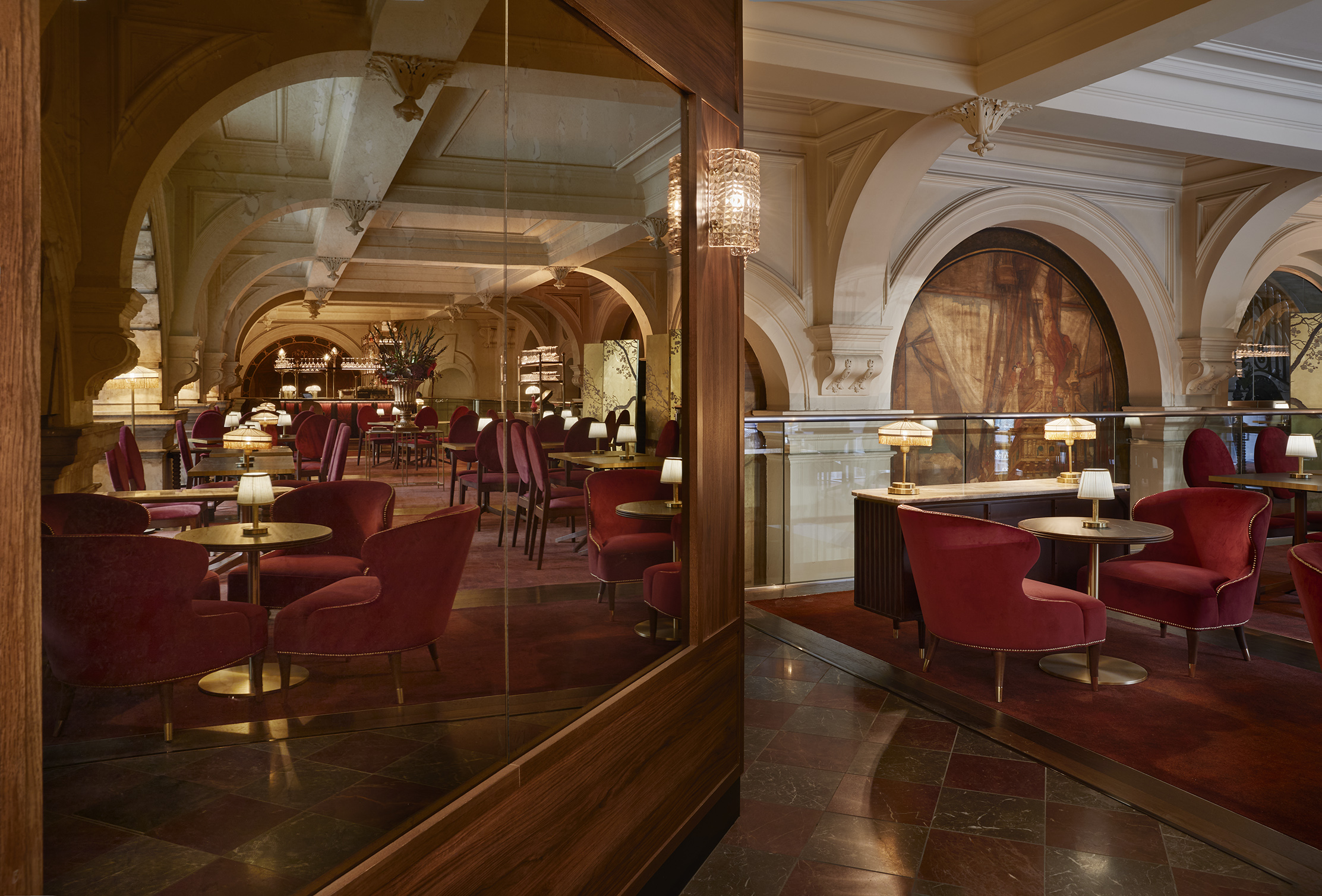 Engel Bar: Elegant meeting space with plush red seating for networking events.