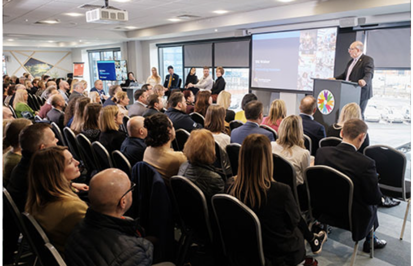 "Engaged audience at Connexin Live auditorium during a professional conference"