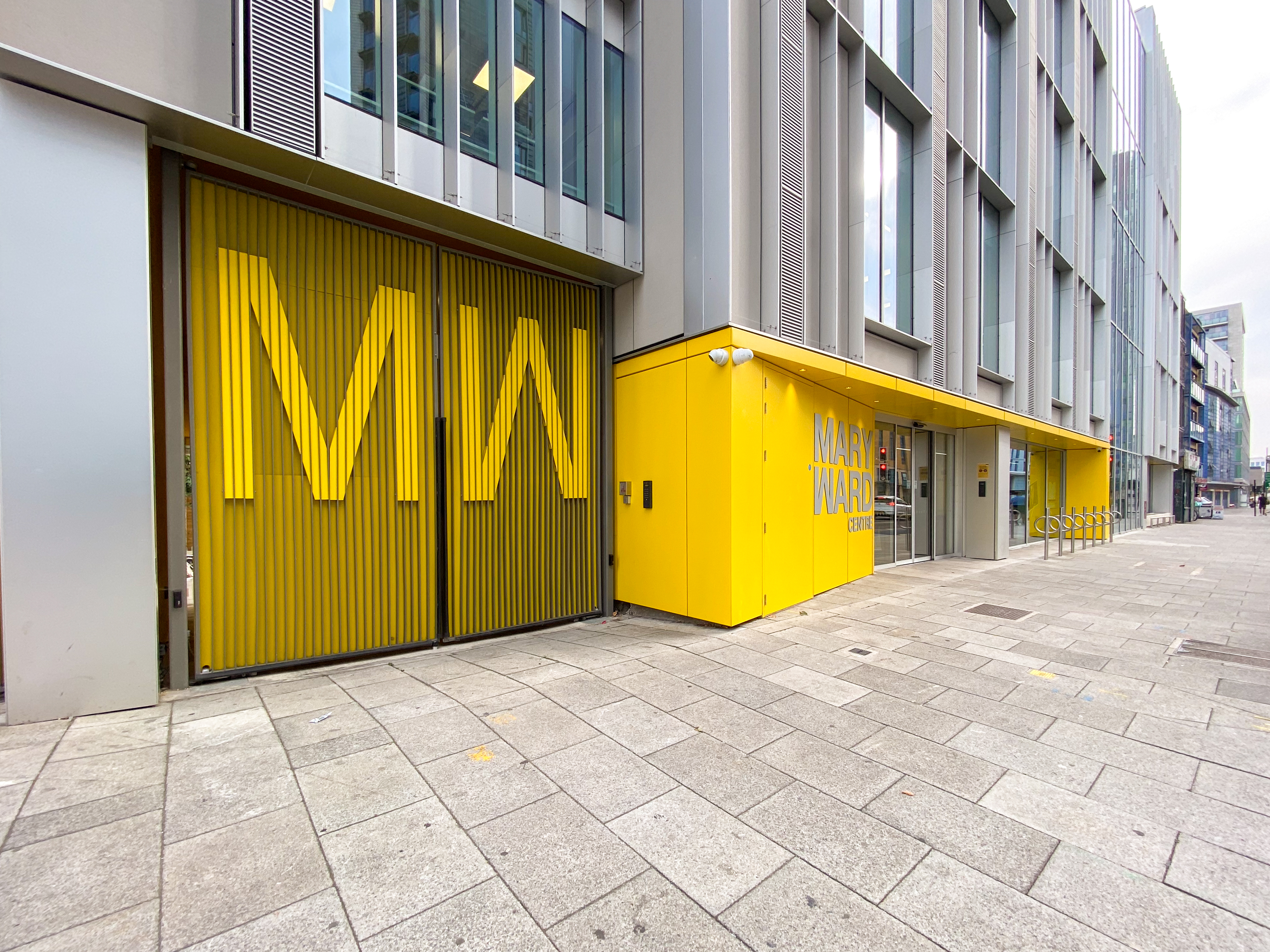 Modern Wellbeing & Performance Studio with yellow accents, ideal for events and workshops.