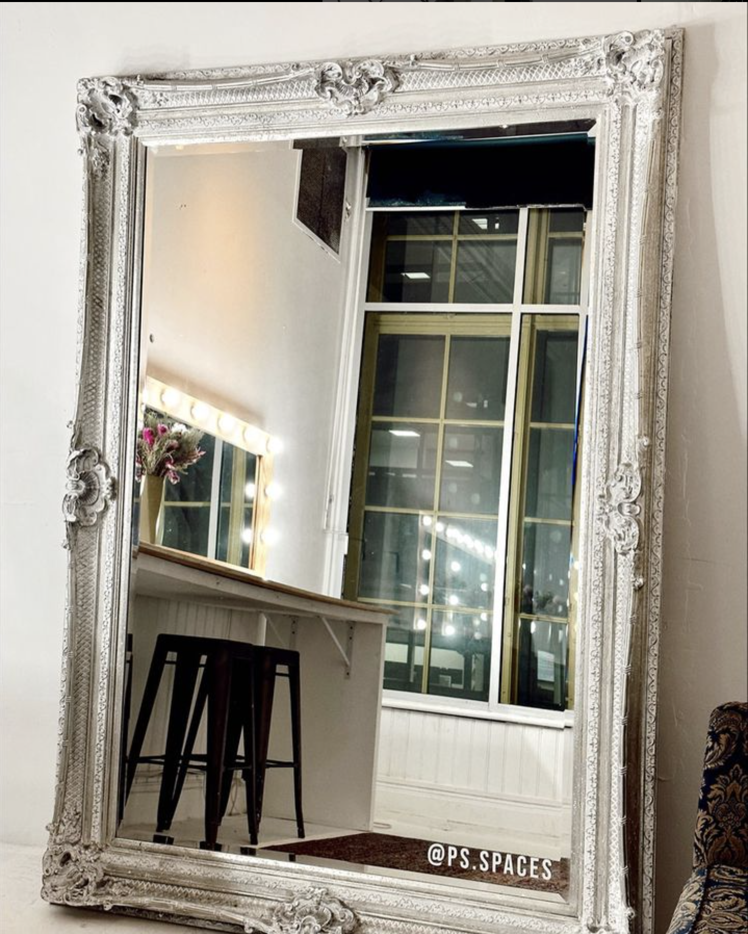 Stylish vanity with ornate mirror and Hollywood lights in PS Spaces Studio for events.