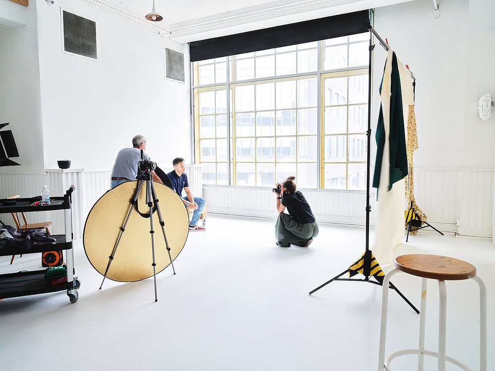 Well-lit photography studio with large windows, ideal for branding events and photoshoots.