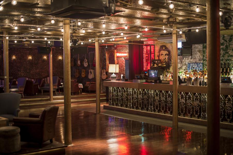 Stylish cocktail bar with rustic decor, perfect for events and receptions.