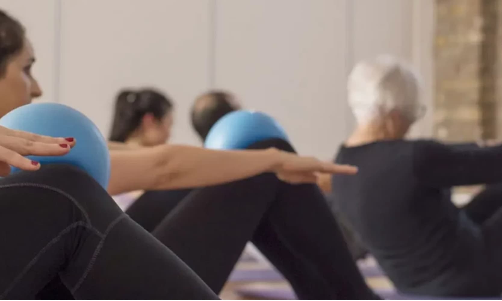 Group fitness class with exercise balls in triyoga Treatment Rooms for corporate wellness events.