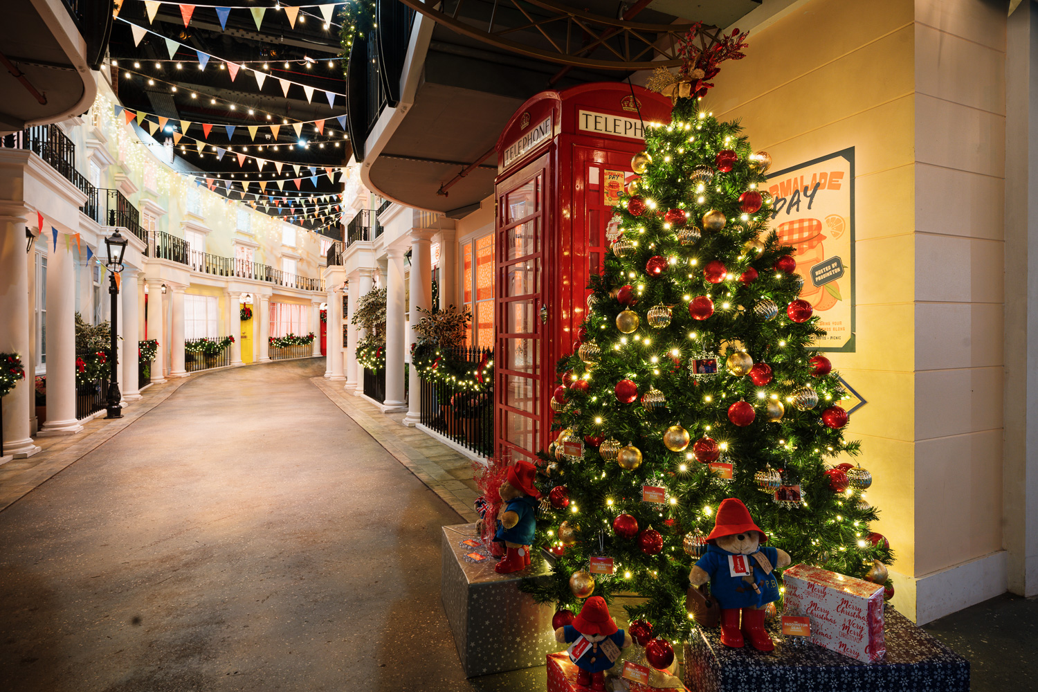 Christmas party at Paddington Bear Experience with festive tree and vibrant decor.