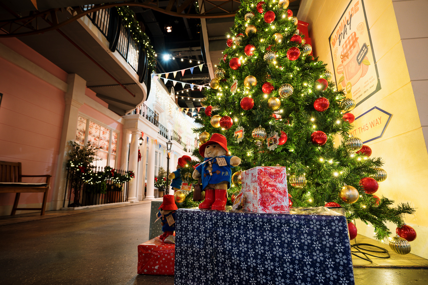 Christmas party at The Paddington Bear Experience with a decorated tree and gifts.