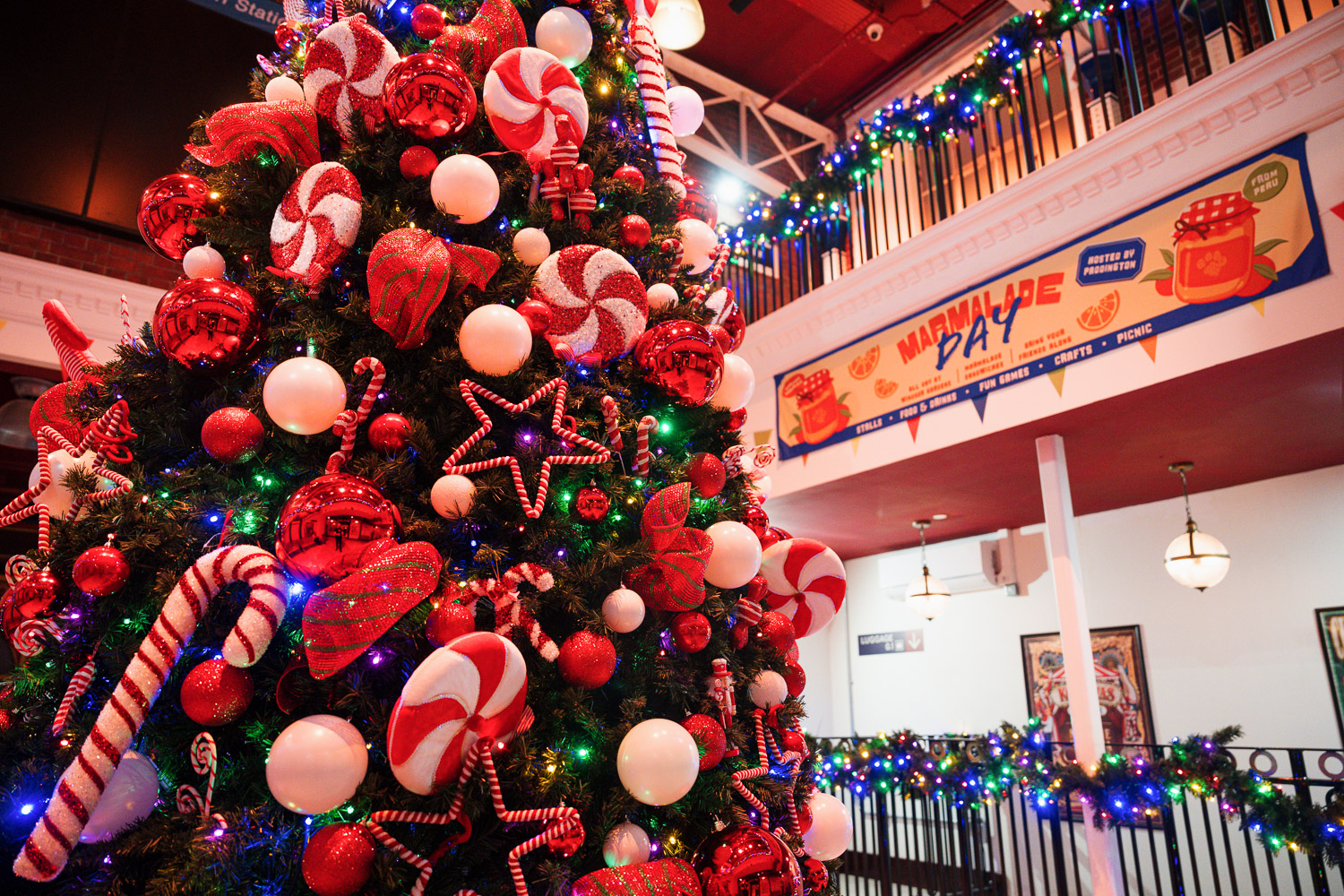 Christmas party at Paddington Bear Experience with a decorated tree and festive decor.