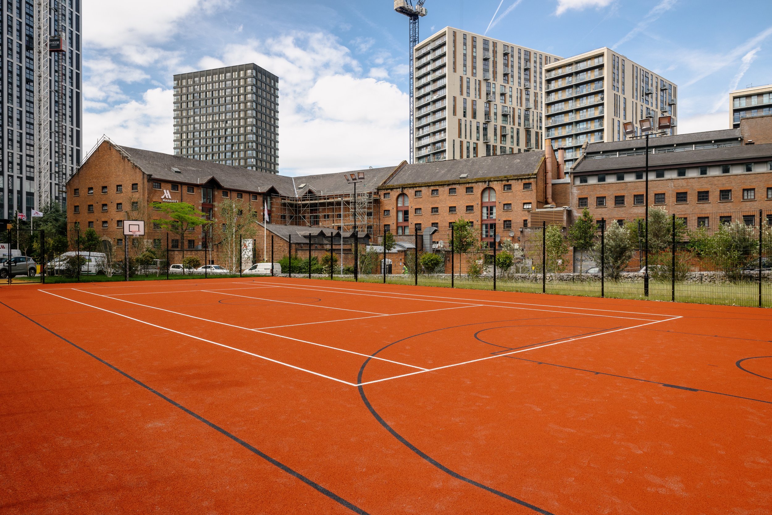 Vibrant orange sports court at Courts Club, perfect for team-building events and recreation.