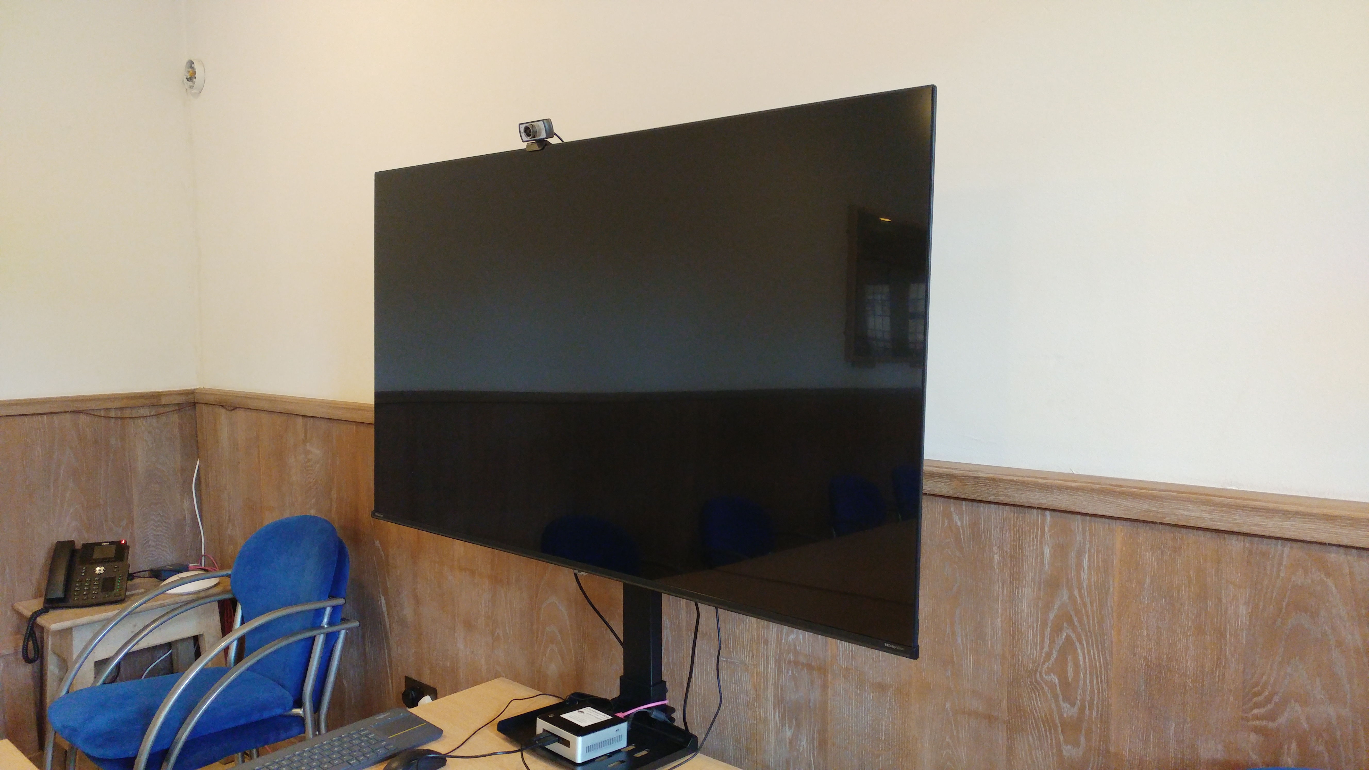 "Chapter House in Bradford Cathedral with wall-mounted screen for hybrid meetings"