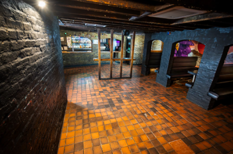 Rustic event space with exposed brick walls at Bacchus Late Bar for gatherings and meetings.