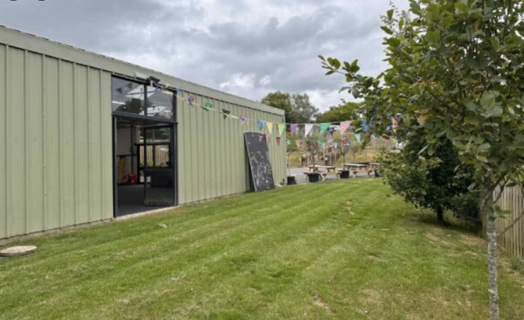 Versatile UpCountry Events Barn with festive bunting, perfect for outdoor gatherings and workshops.