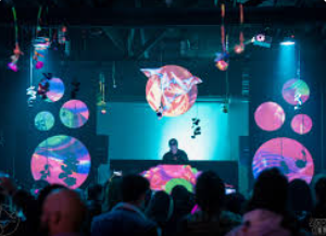 Vibrant DJ setup with colorful lighting in The Blue Bird Reno event space.