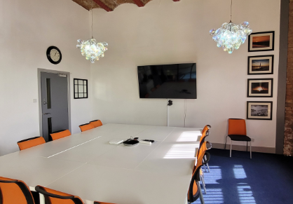 Conference Room at Dockside with large white table, ideal for meetings and events.