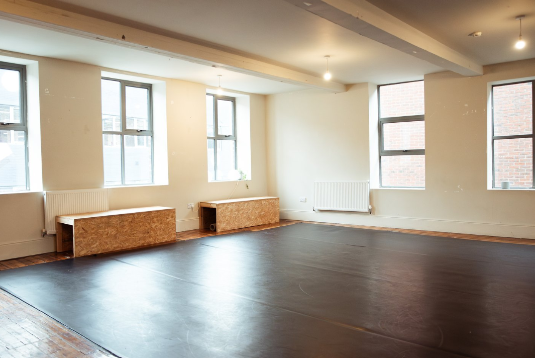Versatile event space with natural light, ideal for workshops and yoga classes.