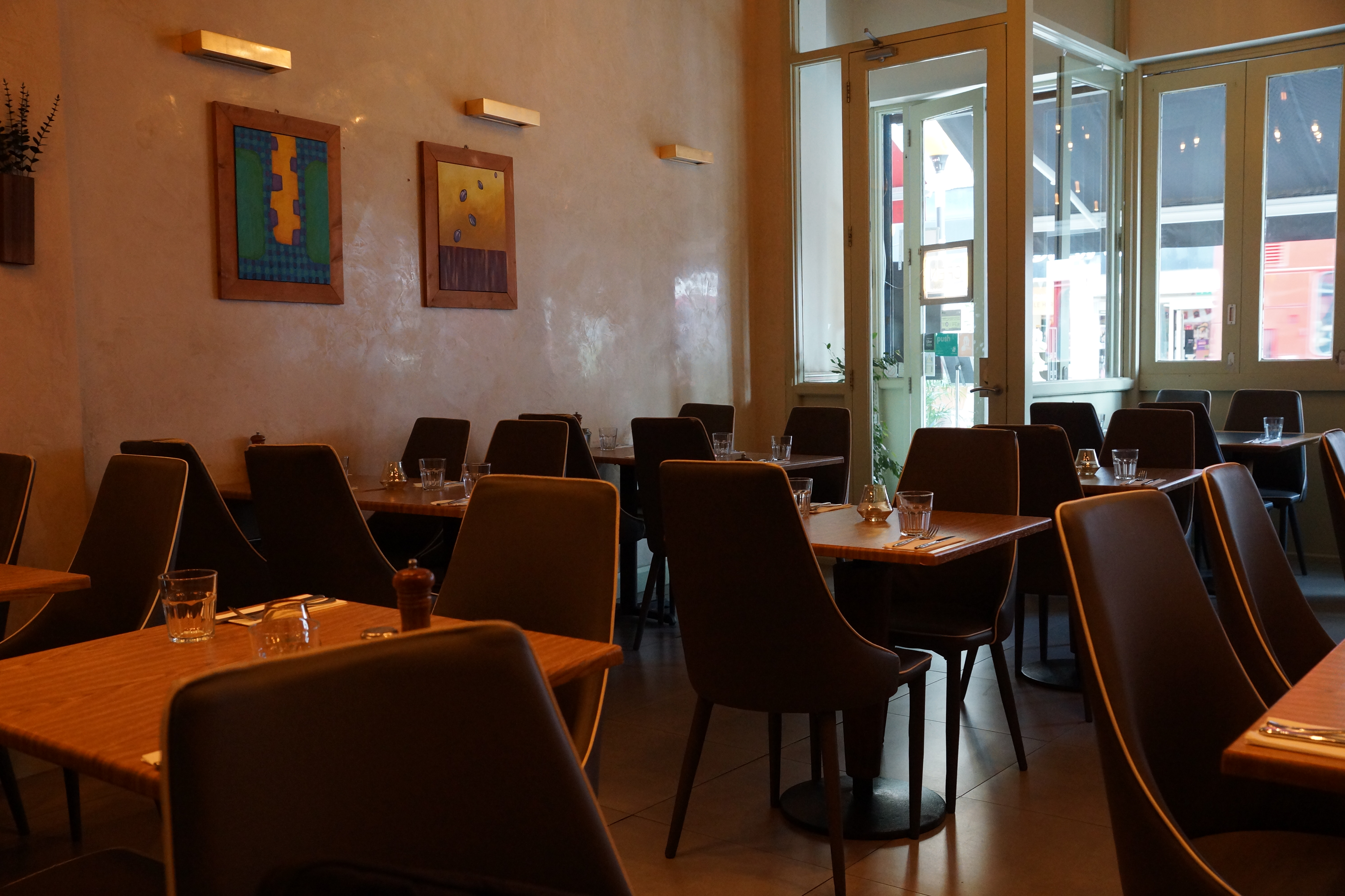 Well-lit Koka Restaurant with inviting decor, perfect for intimate gatherings and meetings.