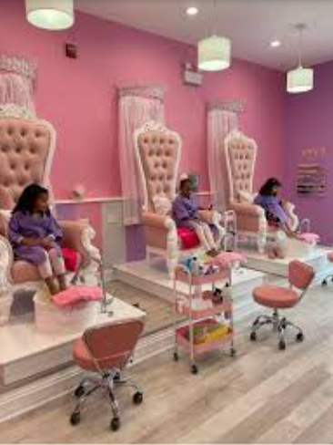 Board games in a vibrant children's spa with elegant pink throne chairs for parties.