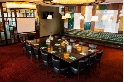 Private event hire meeting room with polished table, ideal for workshops and strategic meetings.