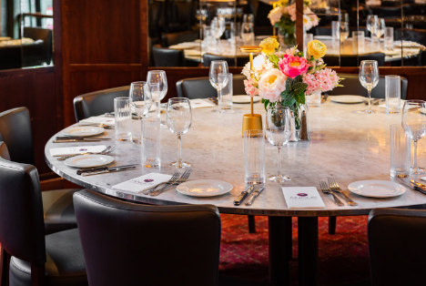 Elegant round dining table setup for private events in Angus Executive.