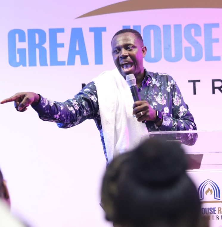Dynamic speaker engaging audience at Great House Revival Ministries event.