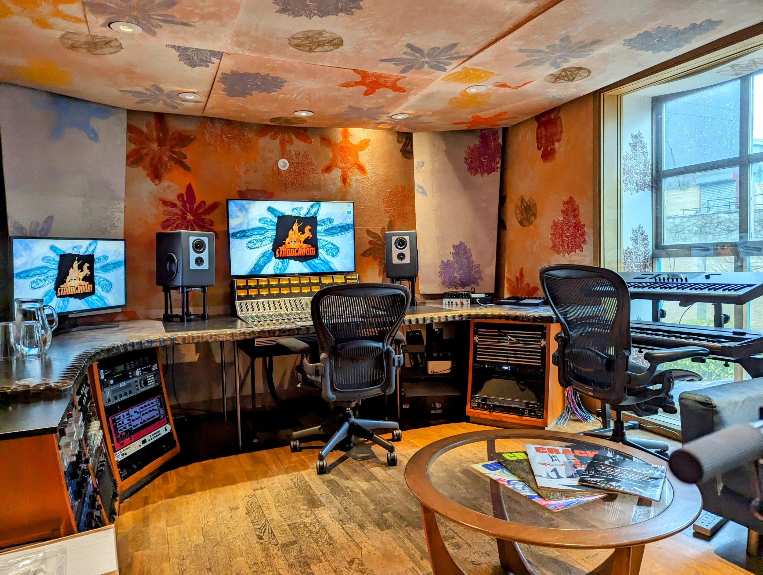 Modern audio production studio with dual monitors for music workshops and recording sessions.