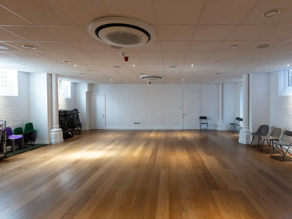 Versatile event space in DB Music London with polished wooden floor for meetings and gatherings.