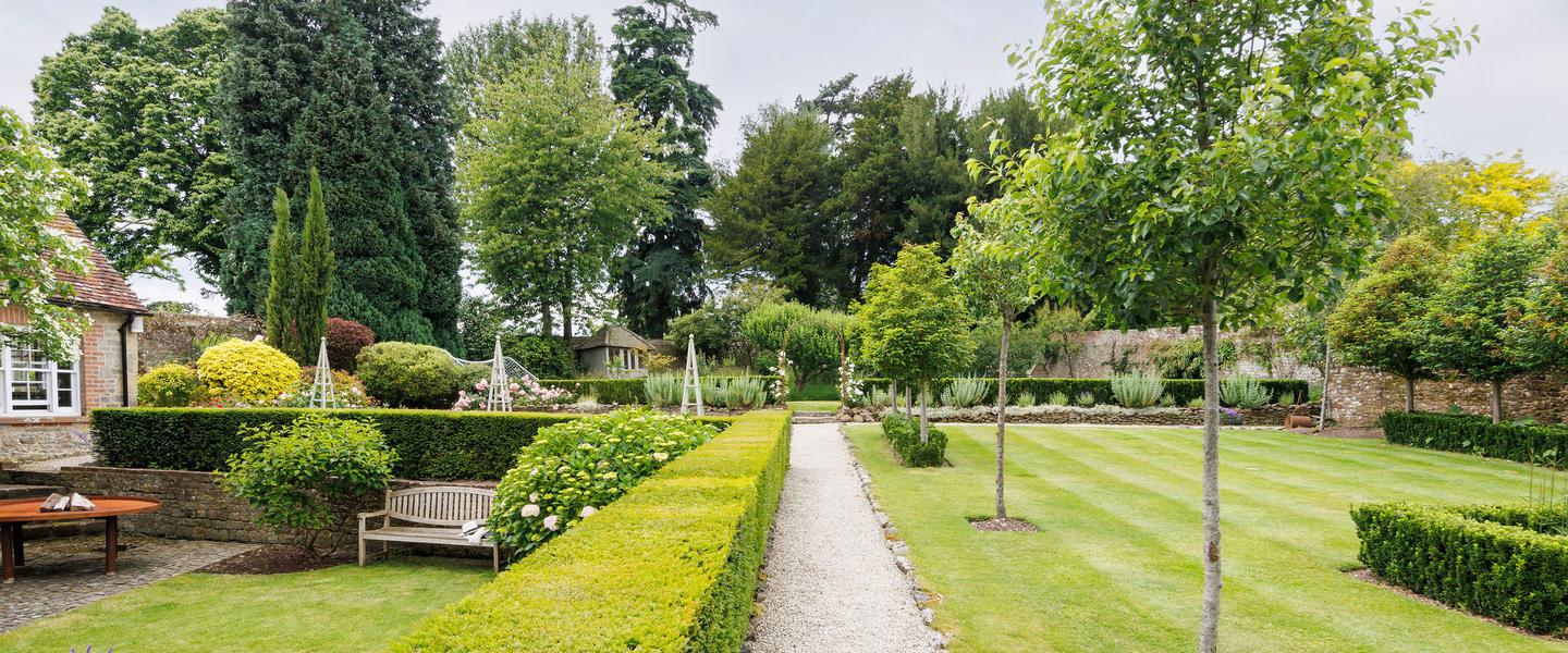 Orangery garden venue with lush greenery, ideal for weddings and corporate events.