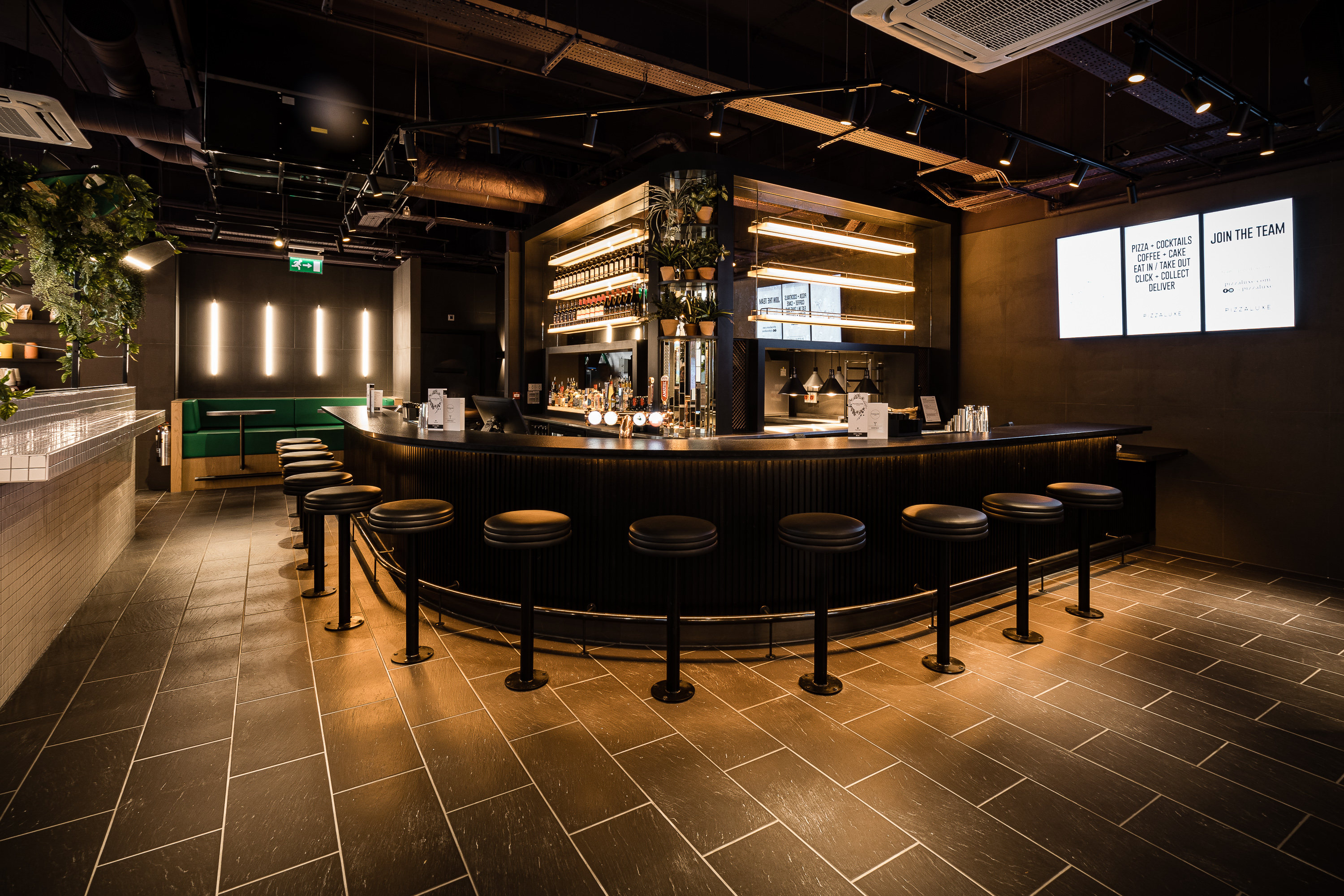 Sleek bar area at PizzaLuxe Manchester for networking events and cocktail receptions.