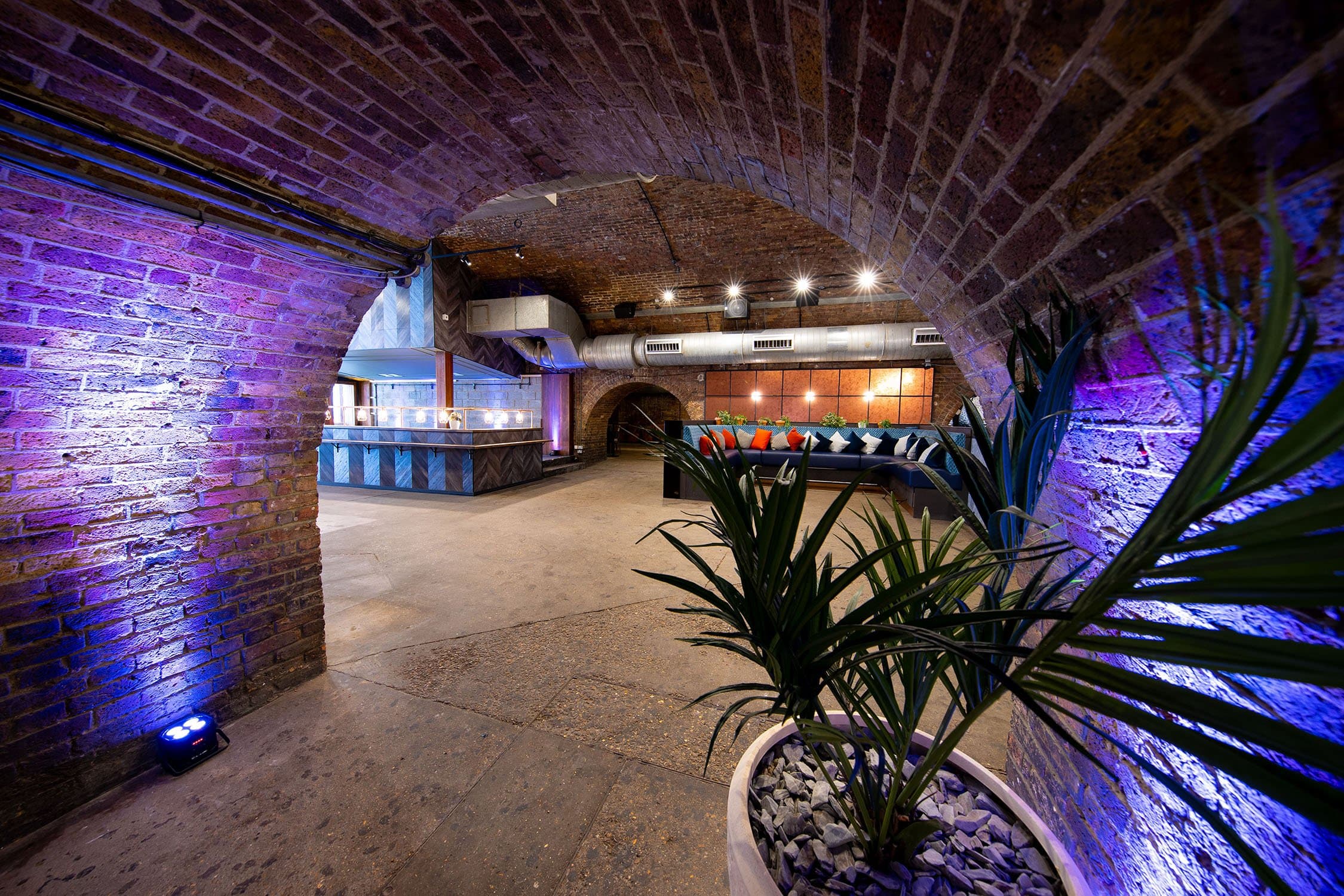 Stylish event space with exposed brick arches for gatherings and celebrations.