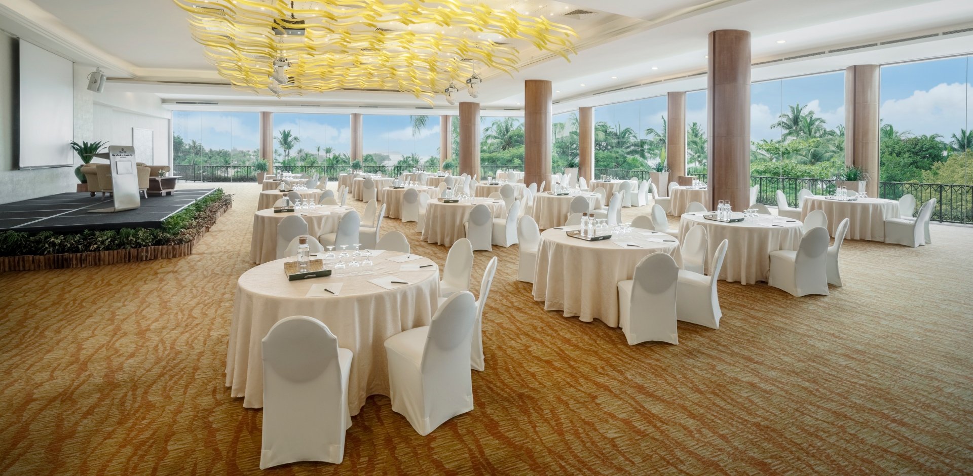Spacious Shangri-La Singapore meeting room with elegant round tables for events.