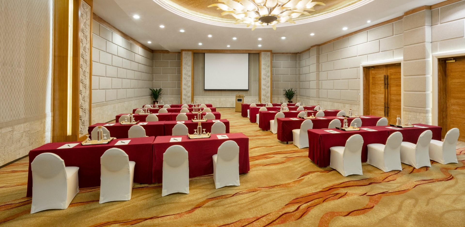 Meeting room in Shangri-La Singapore, red tables and white chairs for conferences and workshops.