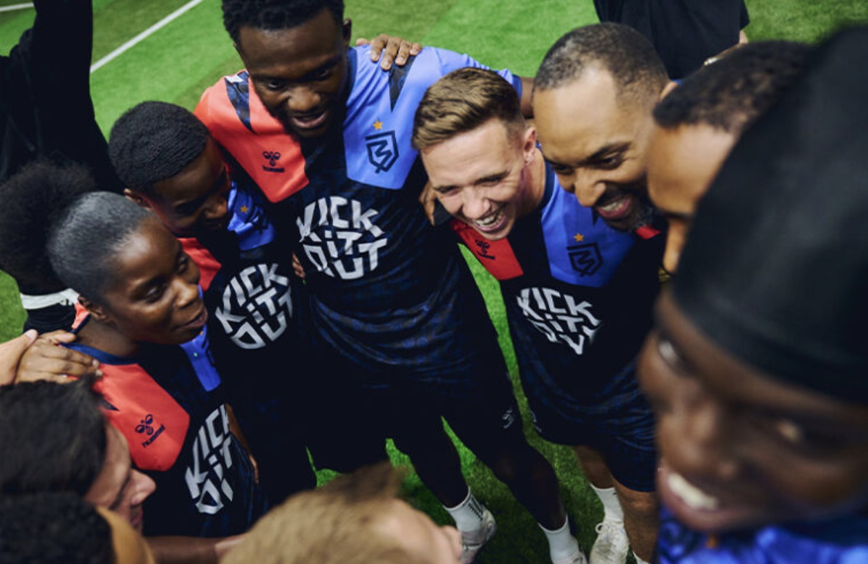 Diverse athletes huddle, showcasing teamwork at corporate sports events in Ballerz.