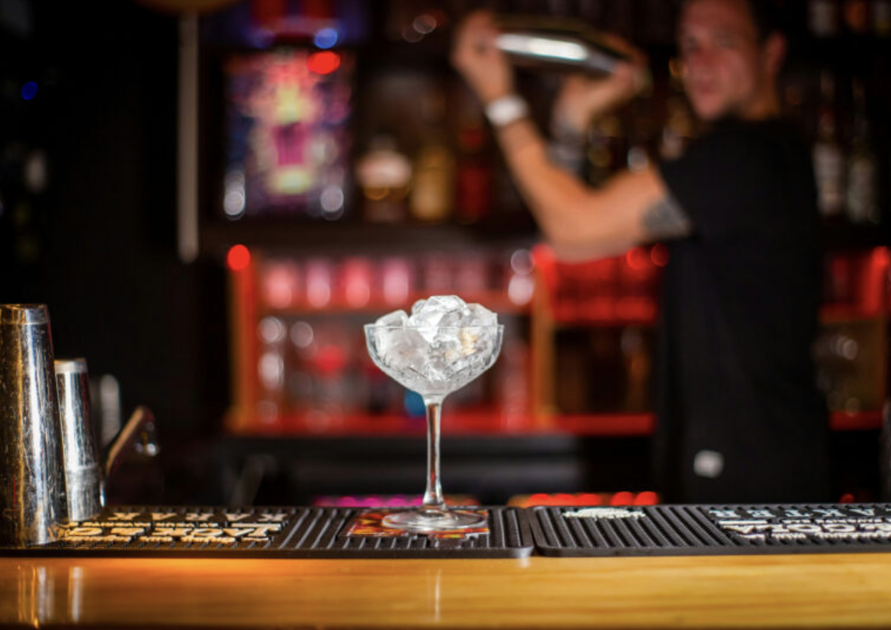 Cocktail preparation at a stylish bar for corporate networking events.