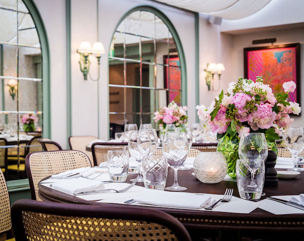 Elegant private dining room with floral centerpiece for corporate events and dinners.