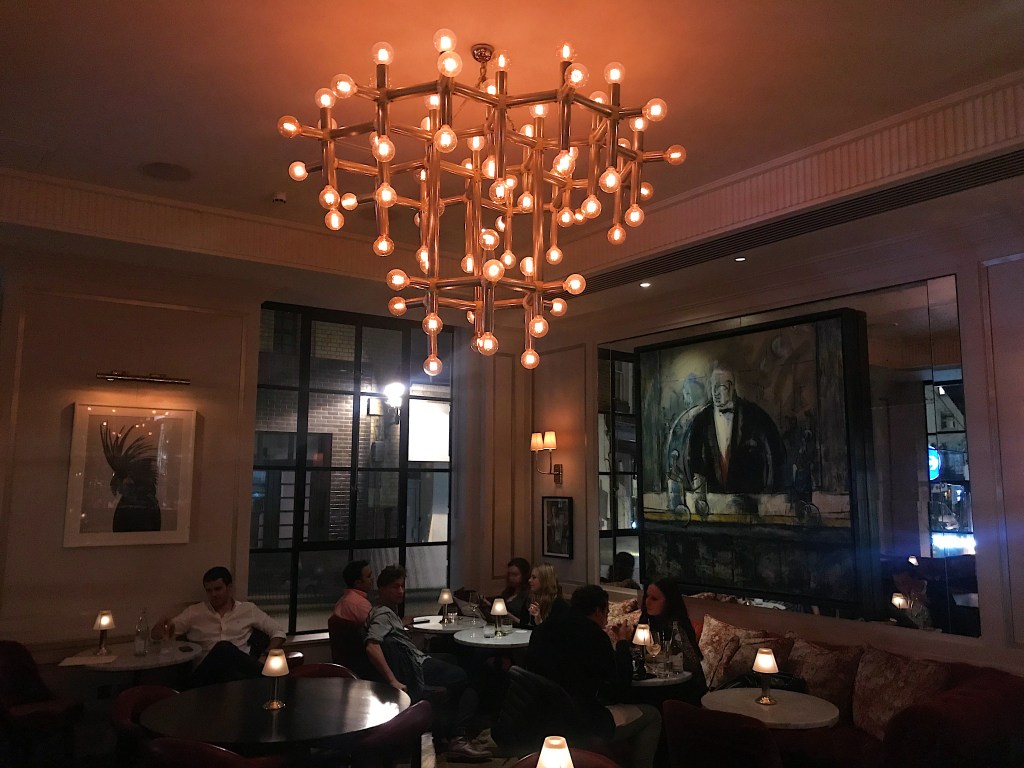 Stylish bar in Daphne's with warm lighting, ideal for networking events and gatherings.