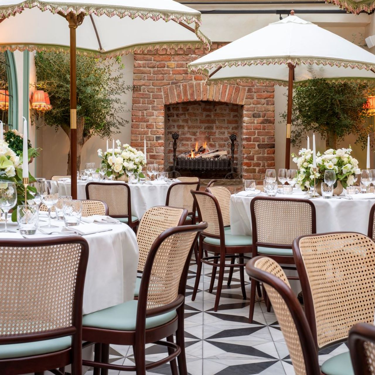 Elegant dining space in Daphne's with floral centerpieces for upscale events.
