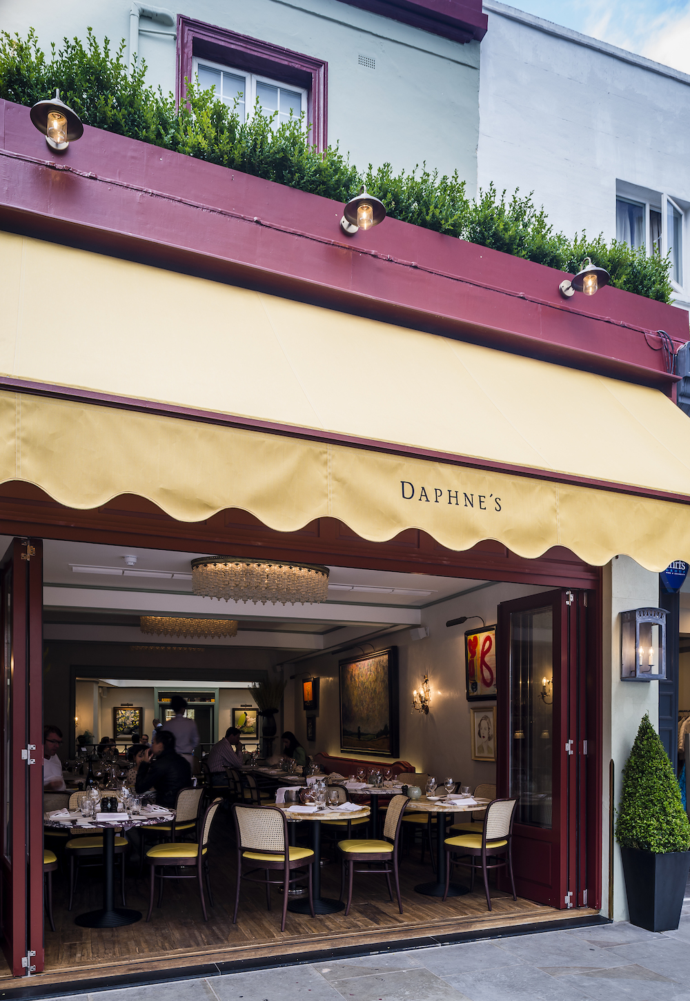 Charming Daphne's restaurant entrance with elegant yellow awning for upscale events.