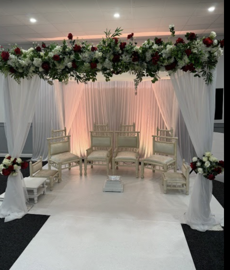 Elegant event space with floral canopy, ideal for weddings and intimate gatherings.