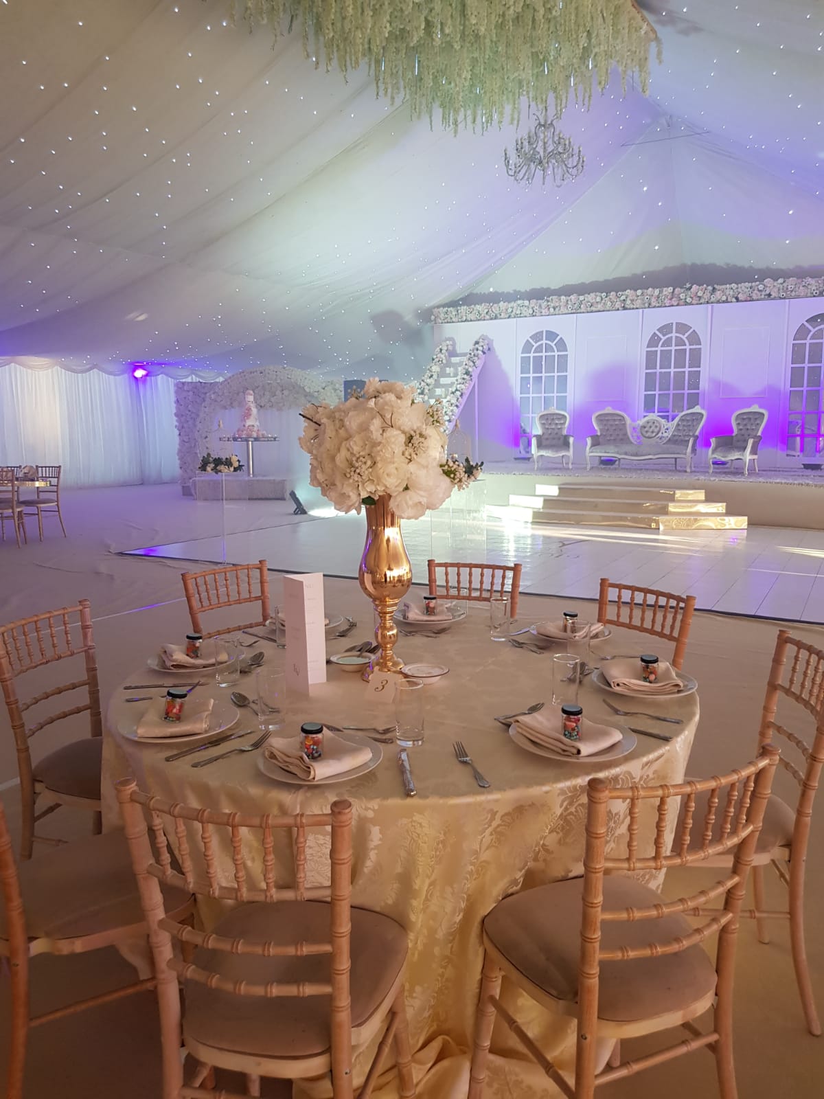 Elegant Grand Marquee event space with floral centerpiece, perfect for weddings and corporate events.