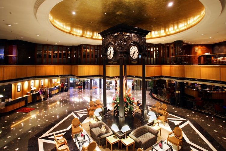 Elegant hotel lobby at Orchard Hotel Singapore with central clock, ideal for events.
