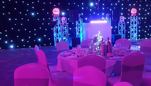 Elegant corporate party venue with round table and soft pink lighting at Crown Hall Farm.