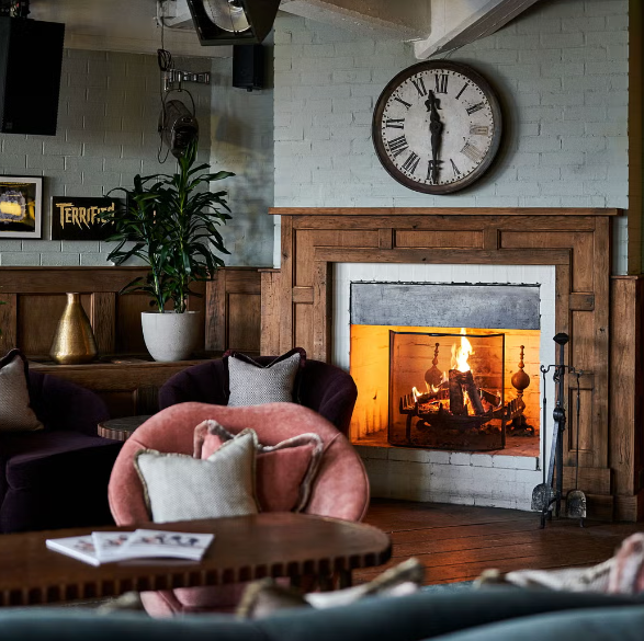 Cozy meeting space with fireplace in Cecconi's Shoreditch for intimate gatherings.