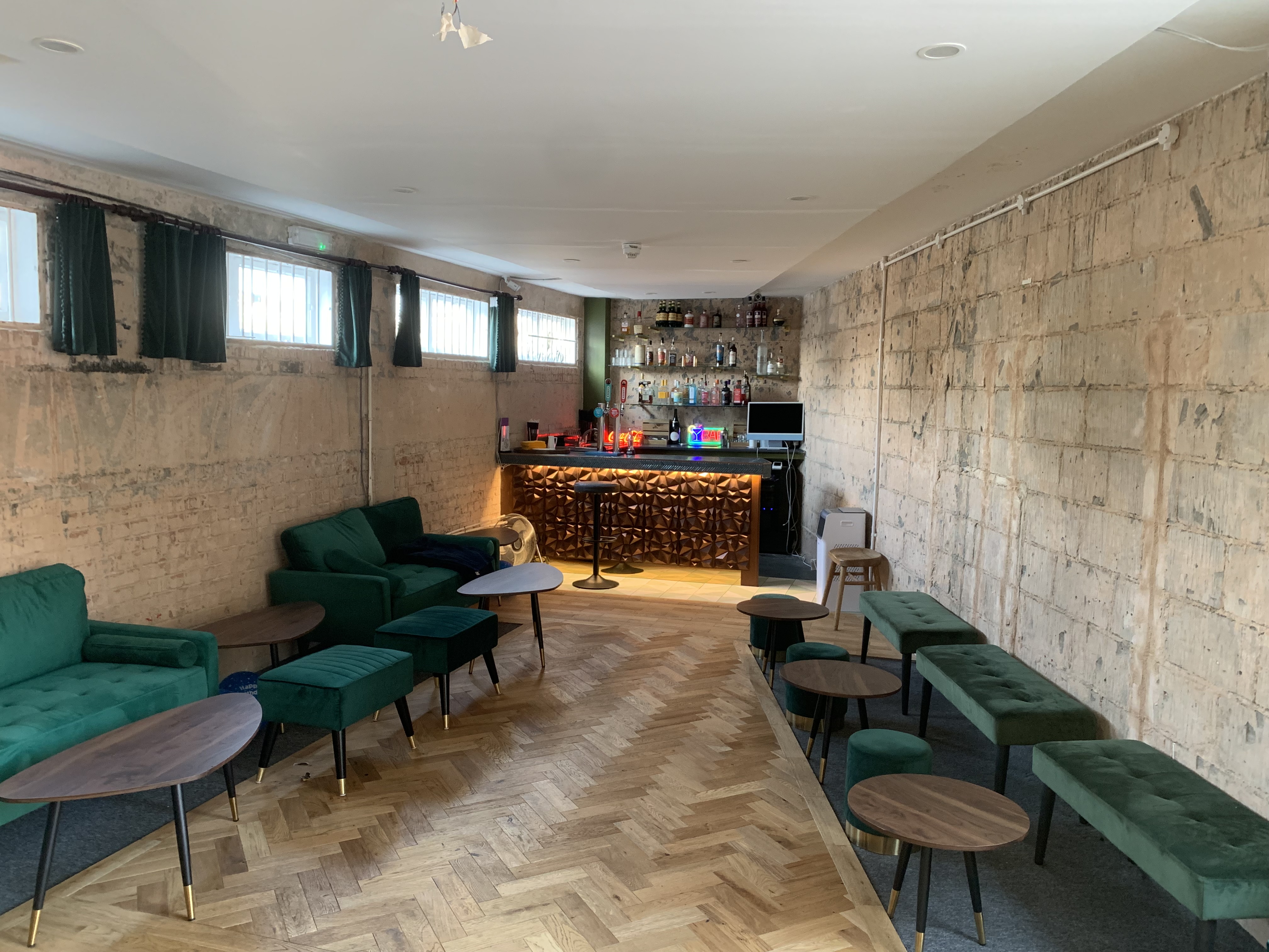 Stylish cocktail lounge bar with cozy seating, perfect for networking events.