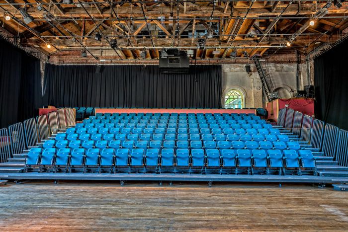 Cornerstone Room auditorium with tiered seating, ideal for performances and workshops.