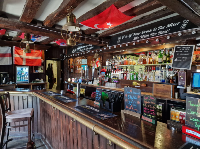 Cozy British Beer Garden in The Long Barn, ideal for social events and networking.