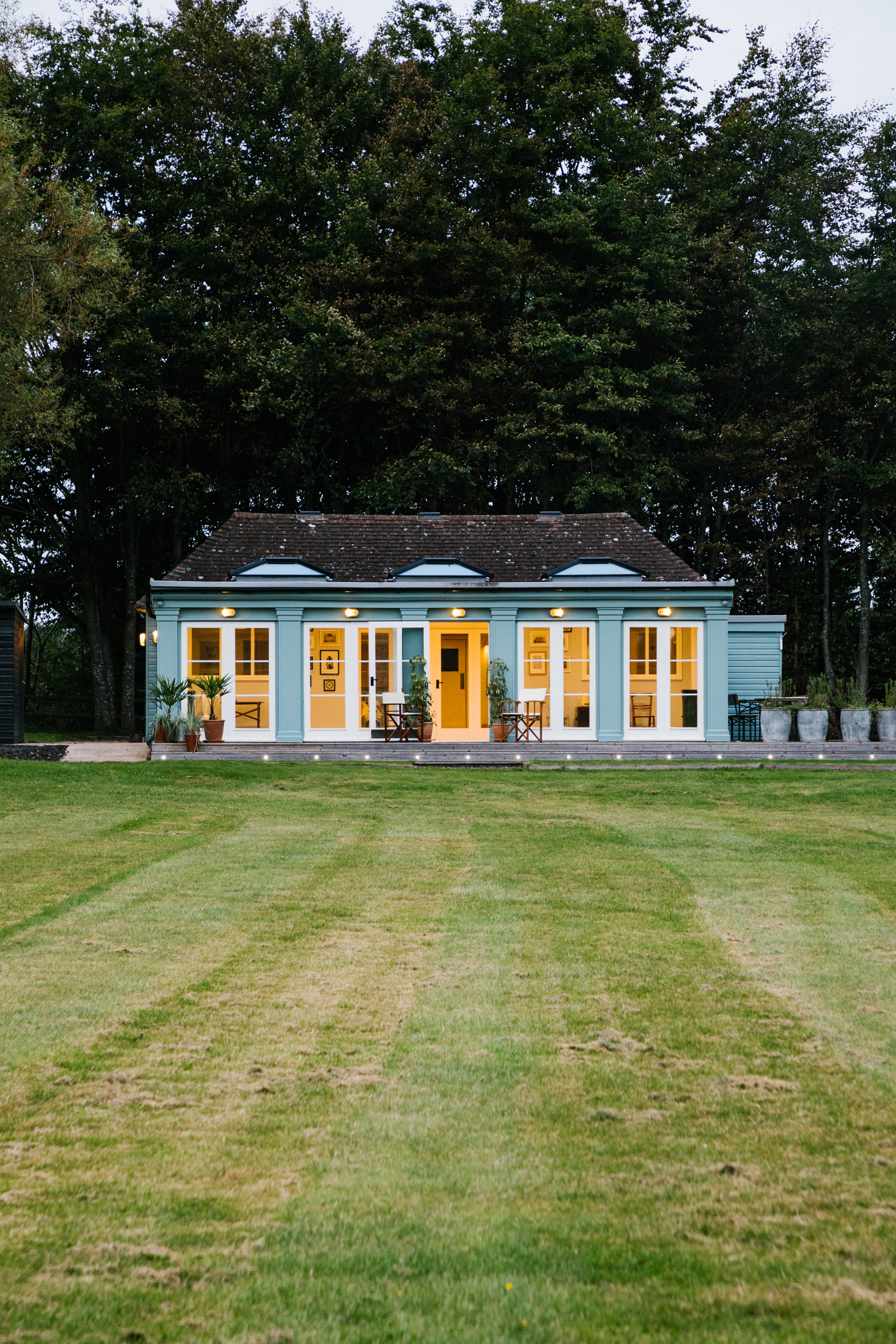 Hawarden Castle Pavilion with blue exterior, ideal for events and retreats.